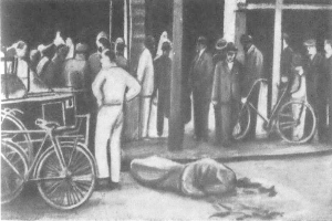 Eine Schwarz-Weiß-Zeichnung eines Mannes, der vor einem Gebäude liegt, umgeben von einer Gruppe von Menschen, einige halten Fahrräder, mit einem Fahrzeug in der Nähe, das den Tod eines Radfahrers in London darstellt.